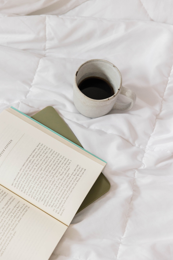 Book, Laptop and Coffee on Bed